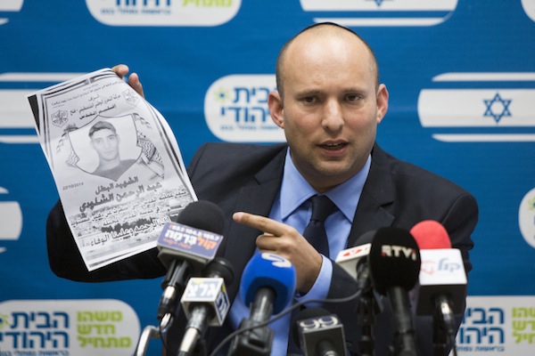Naftali Bennett, leader of the Jewish Home party holds a picture of Adbel-Rahman Shaloudi, a Palestinian from East Jerusalem who drove his car into a train station and killed a woman and an infant, Ocotber 27, 2014. (Yonatan Sindel/Flash90)
