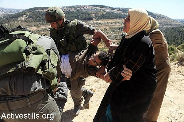 Basel is being arrested by Israeli soldiers during a direct action against the construction of the Seperation Wall in his village, Al Wallaja.	 	 	 	
Basel al-Araj was a well known activist. He participated in many demonstrations and actions against the occupation, including in his village where demonstrations against the building of the wall began in 2006.
