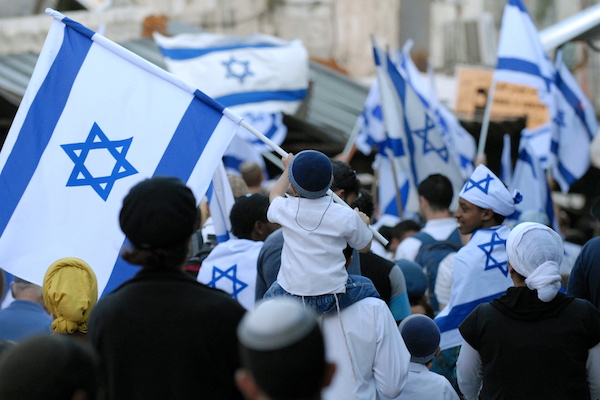 An Israeli child waves an Israeli flag in the Muslim Quarter of Jerusalem's Old city during a march celebrating Jerusalem Day, May 12, 2010. (Gili Yaari/Flash90)