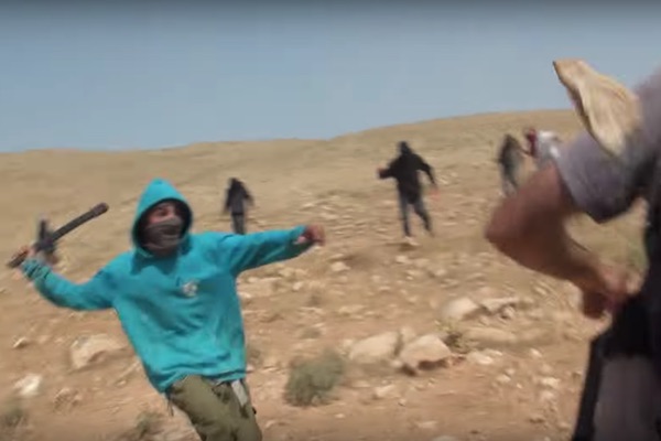 Jewish Israeli settlers attack activists with Ta'ayush in the Jordan Valley, April 21, 2017. (Ta'ayush/Screenshot)
