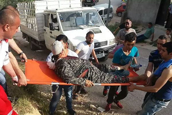 A Palestinian women is stretchered away with a head injury after settlers attacked the village of Huwwara, West Bank, April 22, 2017. (Yesh Din)
