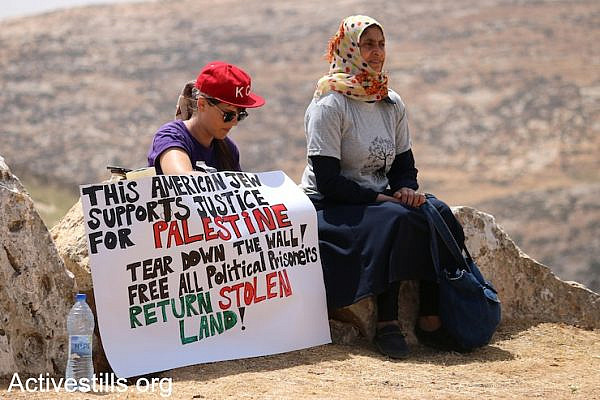 A diaspora Jewish activist sits beside a Palestinian woman at the Sumud Freedom Camp, Sarura, West Bank, May 19, 2017.
