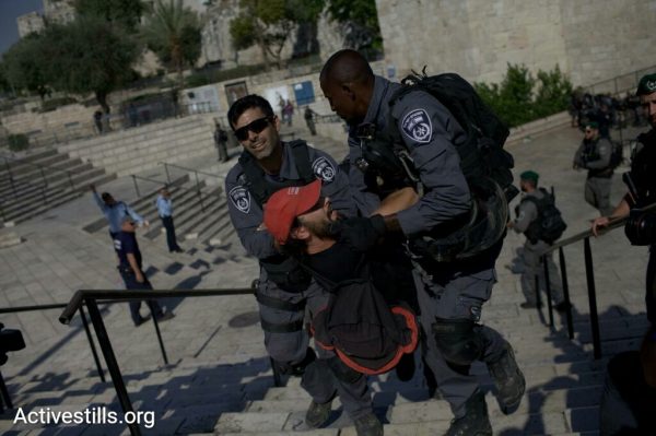 A protester is dragged away by Israeli riot police during a Jerusalem Day protest, Jerusalem, May 24, 2017. (JC/Activestills.org)