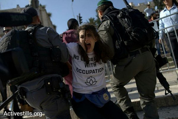 An activist with IfNotNow is carried away by Israeli police during a Jerusalem Day protest, Jerusalem, May 24, 2017. (JC/Activestills.org)