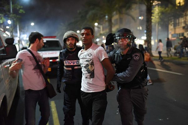 Police arrest a demonstrator during a protest by thousands of Israeli-Ethiopians in Tel Aviv against violence and racism, May 3, 2015. (Ben Kelmer/Flash90)