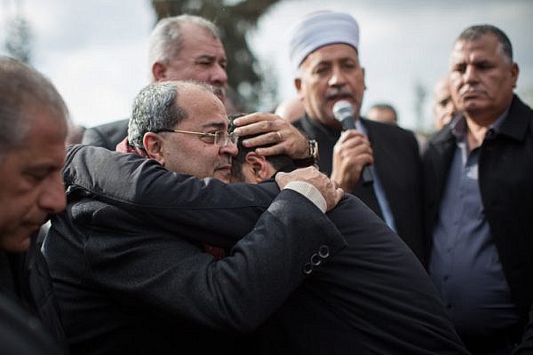 Knesset Member Ahmad Tibi hugs a family member of 19-year-old Lian Zaher Nasser during her funeral in her hometown of Tira, central Israel. Nasser was one of 39 people killed in a terror attack at an Istanbul nightclub shooting on New Years Eve, January 3, 2017. (Hadas Parush/Flash90)