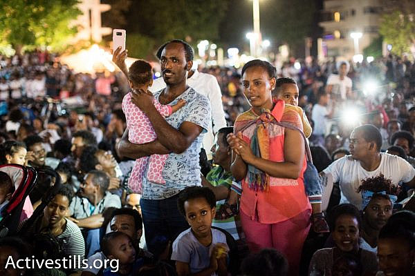A family of asylum seekers seen during a protest against a new law to deduct wages from refugees, Tel Aviv, June 10, 2017. (Activestills.org)