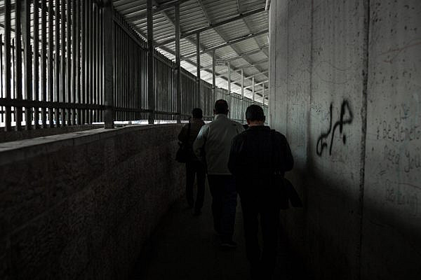 Palestinians walk through an Israeli checkpoint in the West Bank. (Sebi Berens/Flash90)