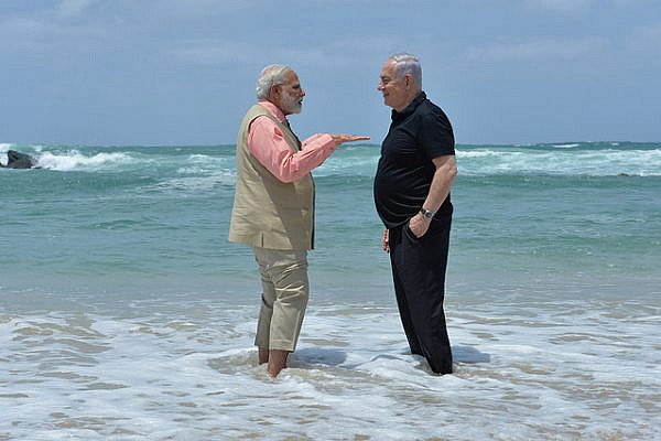 Israeli Prime Minister Benjamin Netanyahu and Indian Prime Minister Narendra Modi get their feet wet at Olga Beach, just 60 miles north of the Gaza Strip. (Kobi Gideon/GPO)