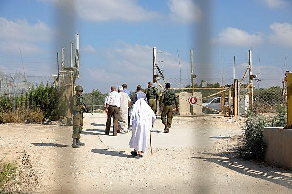 Palestinian farmers negotiate with Israeli soldiers at a military gate in the northern West Bank, demanding the Israeli army ease restrictions to allow them to more easily enter and exit, Deir Al Ghusun, July 9, 2017. (Haidi Motola/Activestills.org)