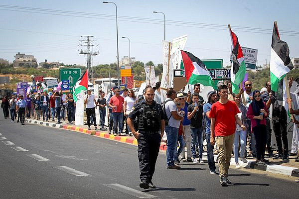 Hundreds of Palestinian and Israeli activists march in an anti-occupation, pro-peace rally on Road 60, the West Bank’s main north-south highway, July 7, 2017. (Wisam Hashlamoun/Flash90)