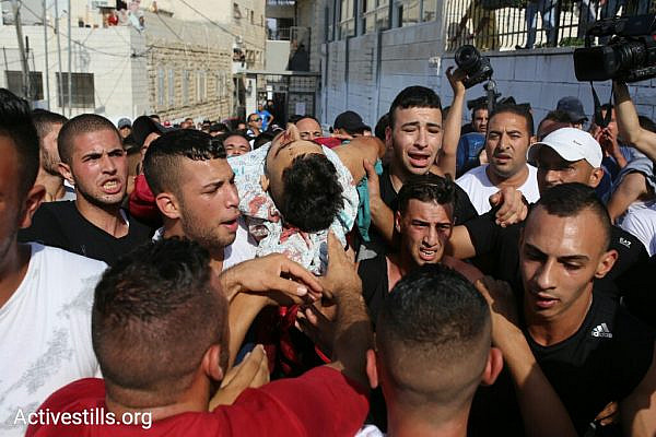 Palestinians in A-Tur, East Jerusalem retrieve the body of a slain Palestinian demonstrator from Makassed Hospital for burial, after he was shot and killed by Israeli forces during a demonstration against the Israeli closure of the Al-Aqsa compound, July 21, 2017. (Oren Ziv/Activestills.org)
