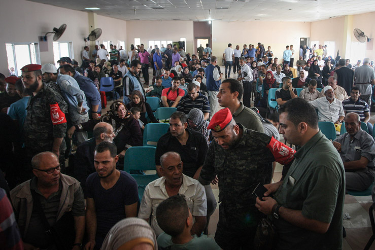 Palestinians wait in the Rafah border crossing terminal during a rare five-day period in which Egypt allowed passengers to pass through. There are an estimated 30,000 Palestinians on a waiting list to leave Gaza through Egypt. August 16, 2017. (Abed Rahim Khatib/Flash90)