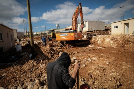 Construction workers clear land for new caravans in the settlement of Ofra, West Bank, January 29, 2017. (Yaniv Nadav/Flash90)