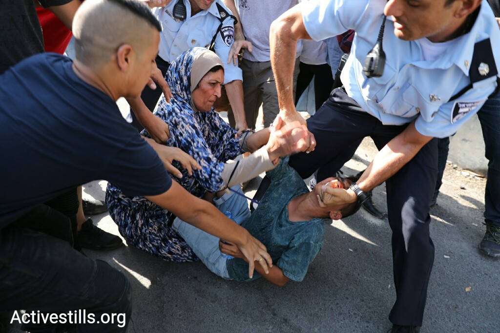 Police arrest a minor during a protest against the eviction of the Shamanseh family from their home in the East Jerusalem neighborhood of Sheikh Jarrah, September 8, 2017. (Oren Ziv/Activestills.org)
