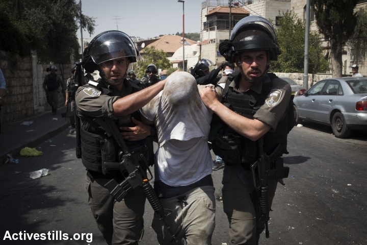 Illustrative photo of Israeli Border Police officers frogmarching a Palestinian detainee in East Jerusalem during the tension surrounding Al-Aqsa Mosque, July 21, 2017, East Jerusalem. (Oren Ziv/Activestills.org)