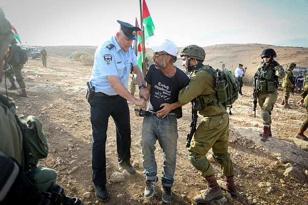 Palestinians and Israeli activists attend a demonstration against the construction of Jewish settlements in the Jordan Valley, West Bank. November 17, 2016. (Flash90)