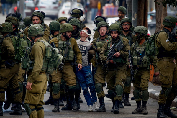 Israeli soldiers arrest a Palestinian youth during a protest against Donald Trump's recognition of Jerusalem as Israel's capital, Hebron, West Bank, December 7, 2017. (Wisam Hashlamoun/Flash90)