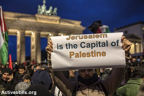 A demonstrator shows a banner during a protest in front of the US Embassy against the US President Trump’s decision to recognise Jerusalem as the new capital of Israel, Berlin, Germany, December 8, 2017. (Anne Paq/Activestills.org)