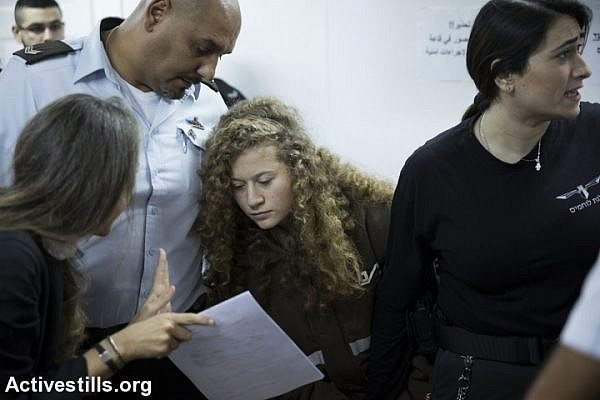 Israeli lawyer Gaby Lasky (L) speaks with her client, sixteen-years-old Ahed Tamimi (R), before she stands for a hearing at the military court in Ofer military prison, near the West Bank city of Ramallah, January 15, 2018. (Oren Ziv/Activestills.org)