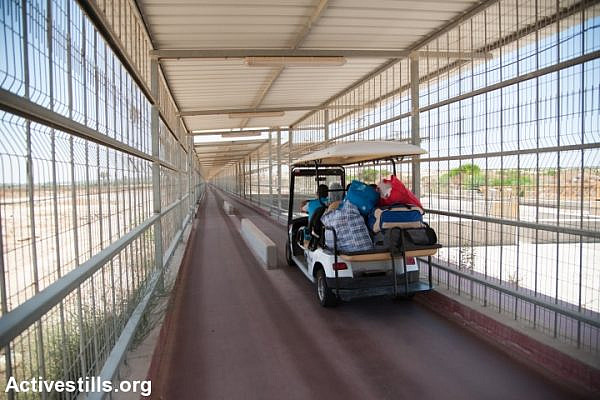 An electric cart provides transportation through the 900-meter caged terminal spanning the restricted access zone at the Erez border crossing between Israel and the Gaza Strip, July 2, 2012. (Ryan Rodrick Beiler)