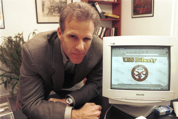 Doing absolutely nothing to dispel doubts about the veracity of his existence as an authentic person, Michael Oren poses with a 'USS Liberty' memorial website. (File photo by Yossi Zamir/Flash90)