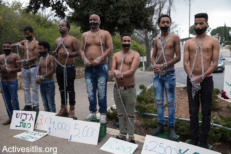 Eritrean asylum seekers stage a mock slave auction outside the Knesset to protest Israel's plans to deport tens of thousands of Sudanese and Eritrean asylum seekers, January 17, 2018, Jerusalem. (Oren Ziv/Activestills.org)