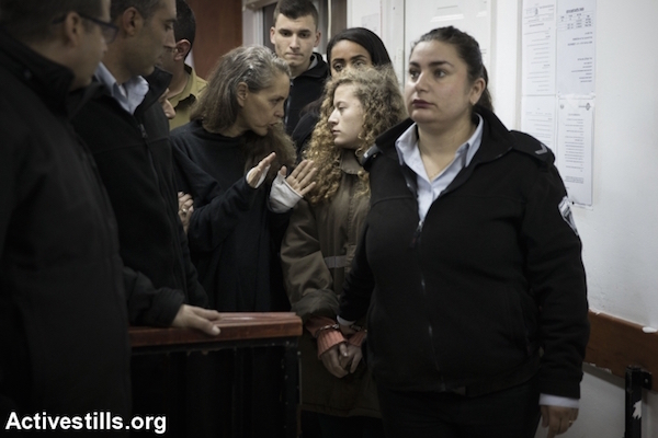 Israeli lawyer Gaby Lasky (C-L) speaks with her client sixteen-years-old Ahed Tamimi (2R) before she stands for a hearing in the military court at Ofer military prison near the West Bank of Ramallah, January 1, 2018. (Activestills)