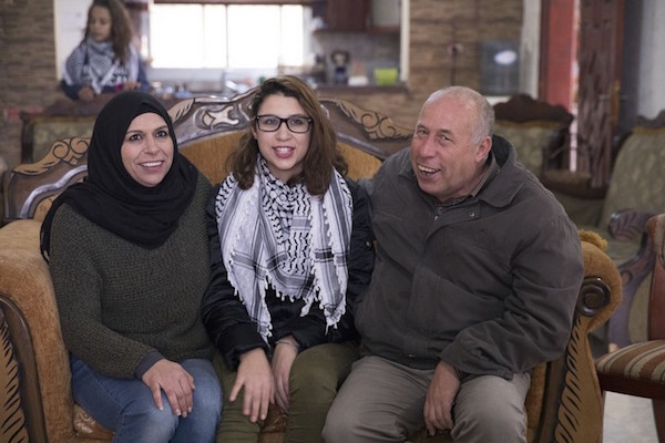 Nur Tamimi with her parents in Nabi Saleh. (Oren Ziv/Activestills.org)