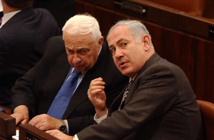 Former Israeli Prime Minister Ariel Sharon speeks with Benjamin Netanyahu (L) during a Knesset session. (Flash90)