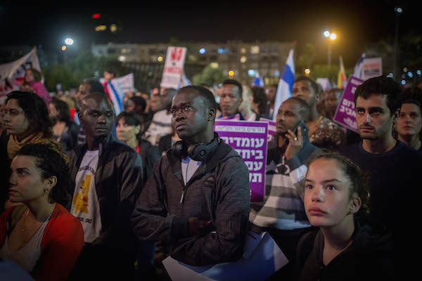 African asylum seekers and human rights activists protest against deportation of asylum seekers at Rabin Square in Tel Aviv on March 24, 2018. (Miriam Alster/Flash90)