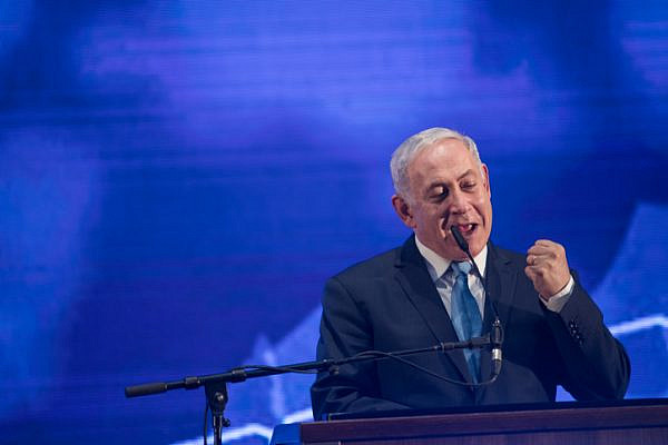 Prime Minister Benjamin Netanyahu speaks during a rally with his supporters and for the Jewish holiday of Passover in Tel Aviv, March 22, 2018. (Hadas Parush/Flash90)