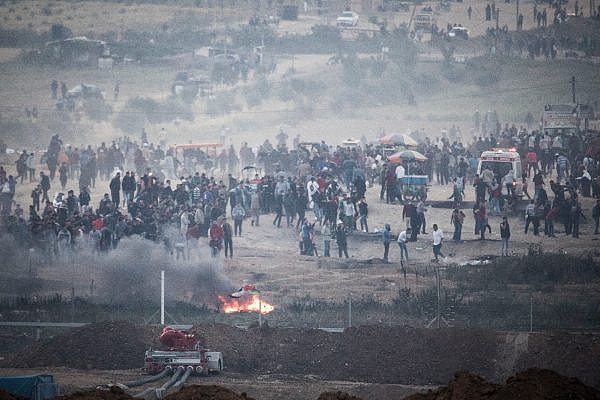 Palestinian protesters in Gaza demonstrate near the border with Israel, during the eighth day of the 'Gaza Return March,' April 6, 2018. (Oren Ziv/Activestills.org)