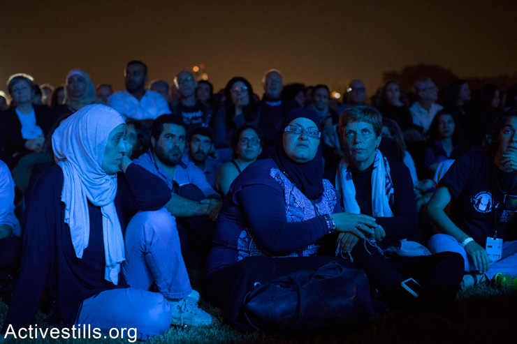Palestinian and Israeli women embrace during the alternative Memorial Day ceremony, April 17, 2018. (Oren Ziv/Activestills.org)