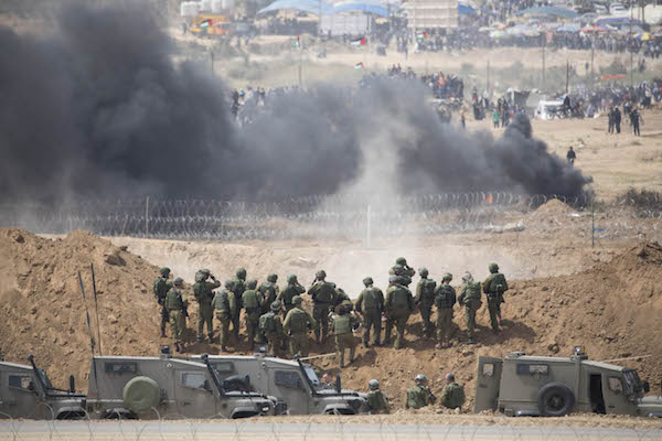 Israeli soldiers face Palestinian protesters in Gaza during the Return March protests. April 13, 2018. (Oren Ziv / Activestills.org)