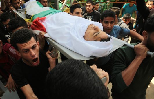 Mourners carry the body of 15-year old Palestinian Jamal Afana, during his funeral in Rafah, southern Gaza Strip, on May 13, 2018. Jamal who was shot in the head by Israeli forces near Rafah in southern Gaza on May 11, succumbed to his wounds the next day. (Abed Rahim Khatib/ Flash90)
