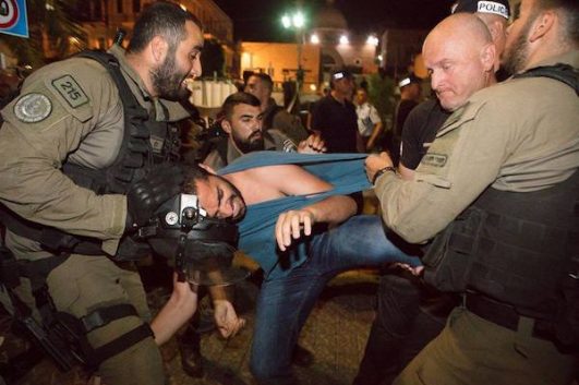 Israeli riot police arrest a protester in downtown Haifa during a demonstration against the mass killings in Gaza, May 19, 2018. (Nadine Nashef)