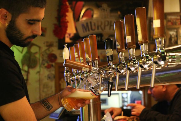 A bartender pours a pint at Kamun Pub. (Steven Davidson)
