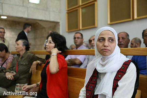 Palestinian poet Dareen Tatour (right) seen with MK Haneen Zoabi in Nazareth Magistrate's Court after the former is sentenced to five months, including time served, for a poem she wrote on Facebook. (Oren Ziv/Activestills.org)