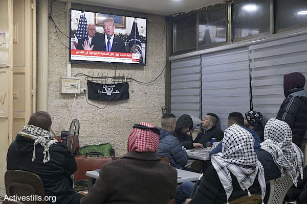 Palestinian men watch Donald Trump give a foreign policy speech in a cafe in East Jerusalem, December 6, 2017. (Oren Ziv/Activestills.org)