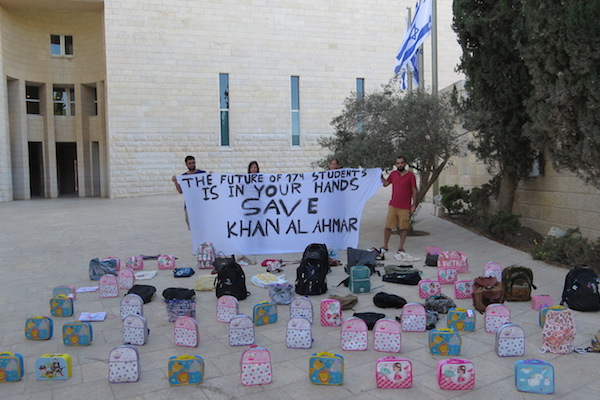 All That's Left activists place backpacks outside Israel's Supreme Court to protest the decision to demolish the village of Khan al-Ahmar, including its eco-friendly school, which serves the local Bedouin population, Jerusalem, July 10, 2018. (Courtesy of All That's Left)