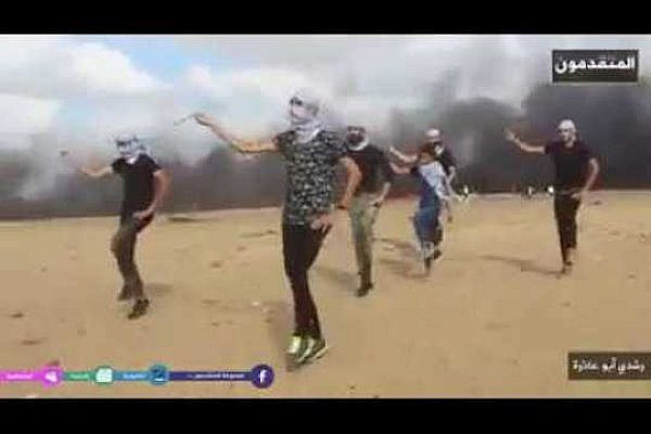 Palestinian youth dance the dabke along the Gaza border. (Screenshot)
