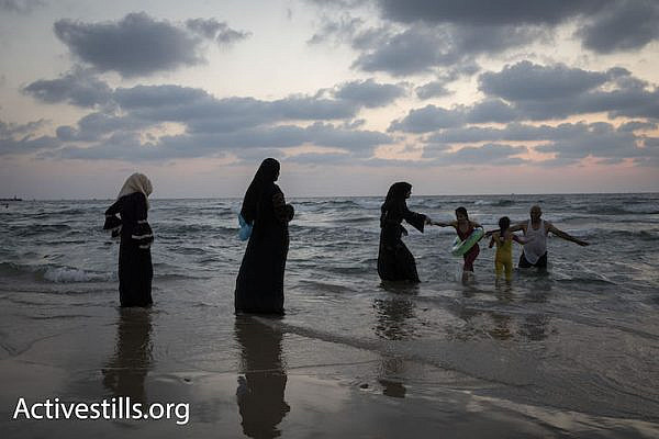 Palestinians from the West Bank swim in the Mediterranean Sea during Eid al-Adha, Tel Aviv, August 22, 2018. (Oren Ziv)