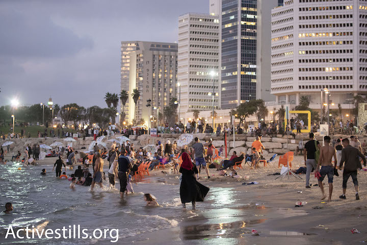 Palestinians from the West Bank swim in the Mediterranean Sea during Eid al-Adha, Tel Aviv, August 22, 2018. (Oren Ziv) 