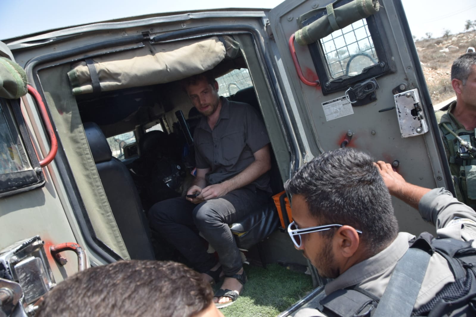 Israeli soldiers detaining Avner Gvaryahu, director of Breaking the Silence, on a tour of the South Hebron Hills, August 31, 2018. (Nasser Nawaja, B'Tselem)