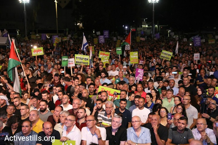Tens of thousands of Palestinian citizens of Israel and their supporters protest in Rabin Sqaure against the Jewish Nation-State Law, August 12, 2018. (Oren Ziv/Activestills.org)