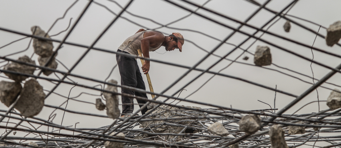 A Palestinian laborer works amongst the rubble of destroyed Palestinian houses damaged during the Israeli-Hamas conflict of 2014, in the Al-Shejaeiya neighbourhood in the east of Gaza City, Gaza Strip, 09 September 2015. According to UN reports, there were 2,251 Palestinians killed between June and August of 2014, about half of them civilians. It also counted six civilians in Israel and 67 Israeli soldiers among the victims of the conflict. Photo by Emad Nassar/Flash90
