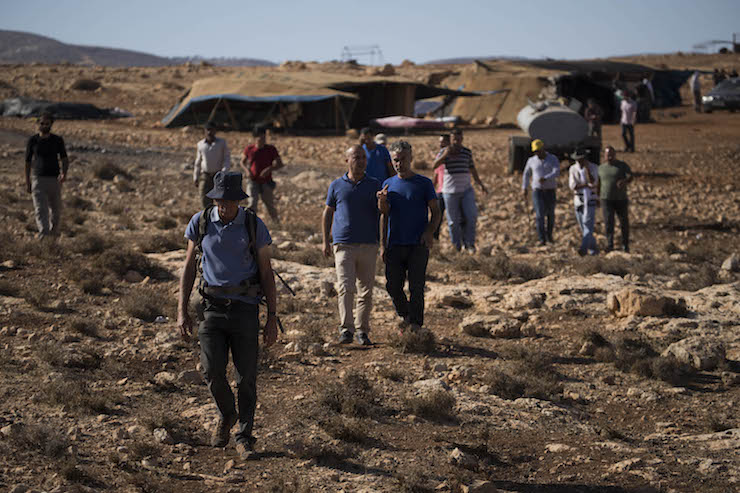 Palestinian, Israeli, and international activists march from the West Bank community of Ein Samia to the village's grazing land, now located between two settler outposts, August 15, 2018. (Oren Ziv)