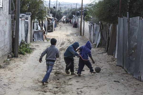 Palestinian refugees play in an impoverished area in Gaza City on January 17, 2018, after the White House froze tens of millions of dollars in aid to UNRWA. (Wissam Nassar/Flash90)