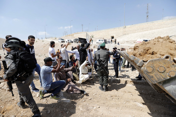 Frank Romano (standing behind the man in black jacket holding a sign), along with Palestinian activists and residents of Khan al-Ahmar, attempt to block an Israeli army bulldozer preparing to demolish the village, September 14, 2018. (Wisam Hashlamoun/FLASH90)